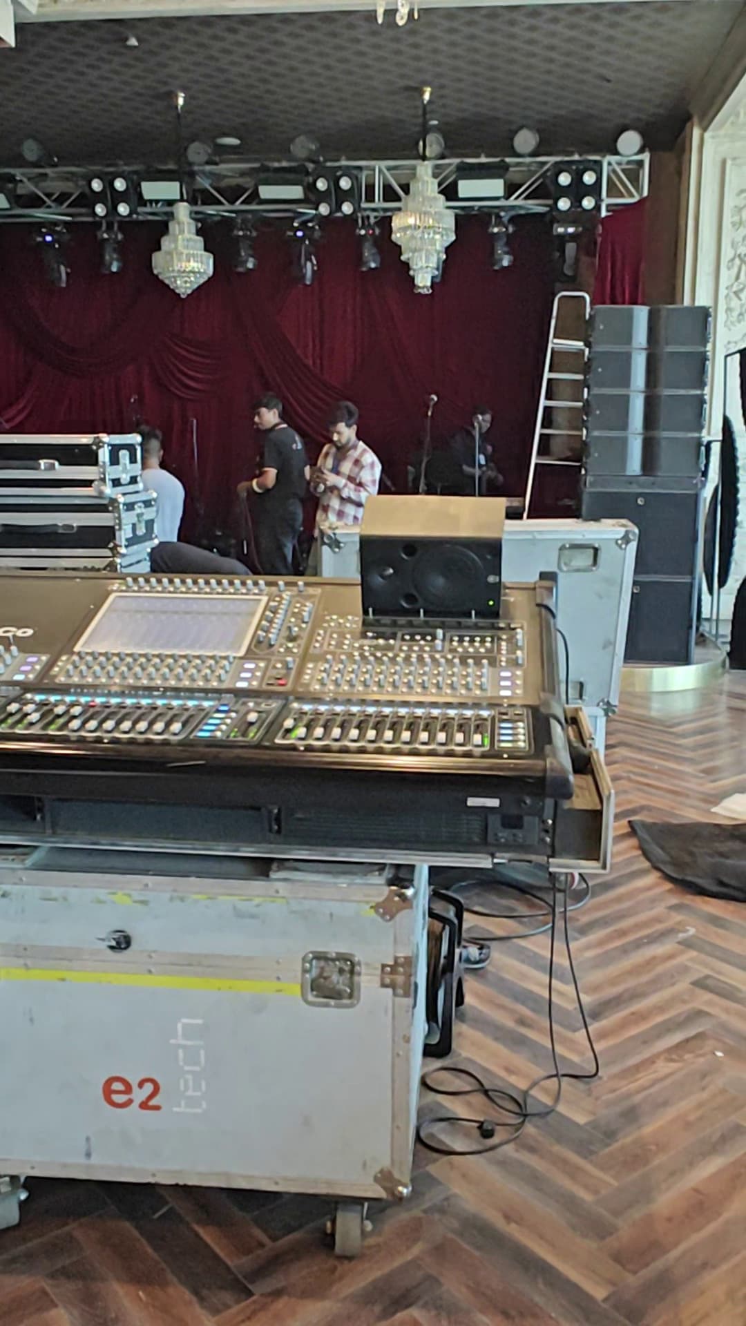 DiGiCo console being configured during sound check — all equipment drawing power from the SmartBatt unit