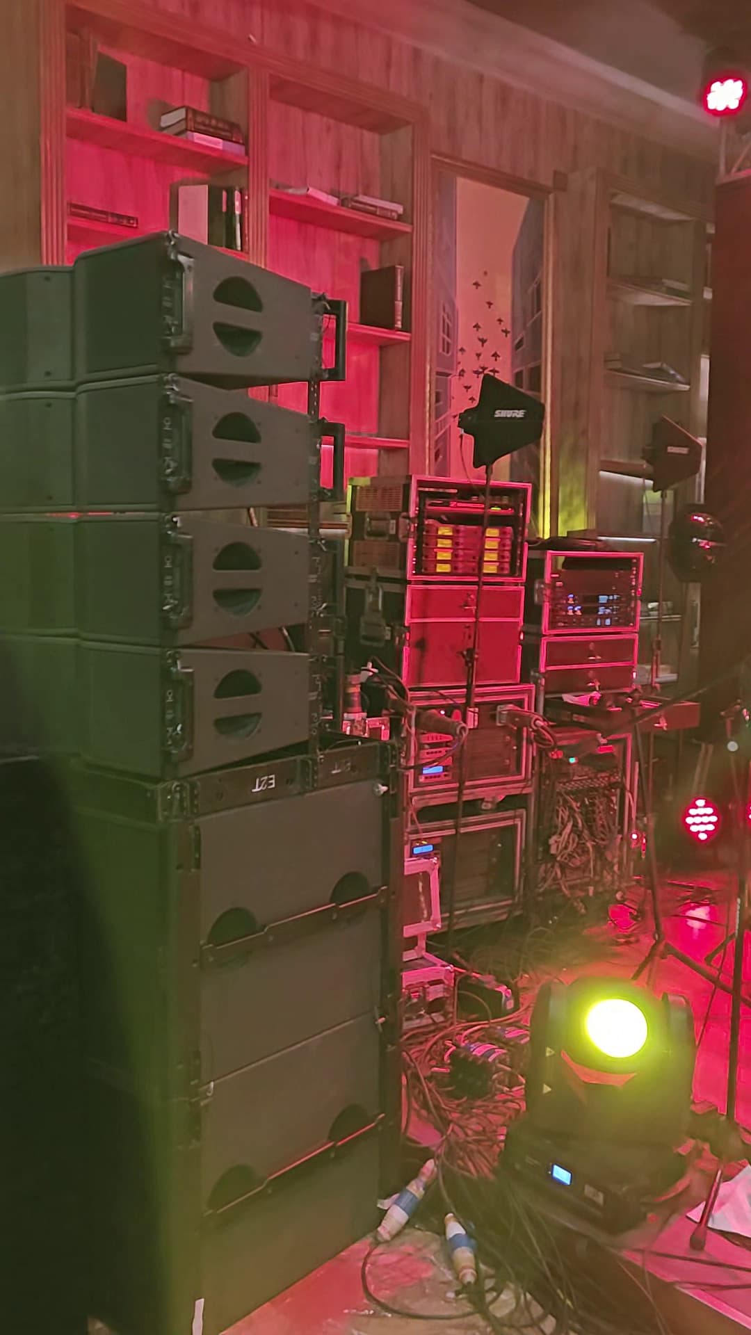Amplifier racks, line array stack, and signal processing equipment — the full audio production load powered by SmartBatt